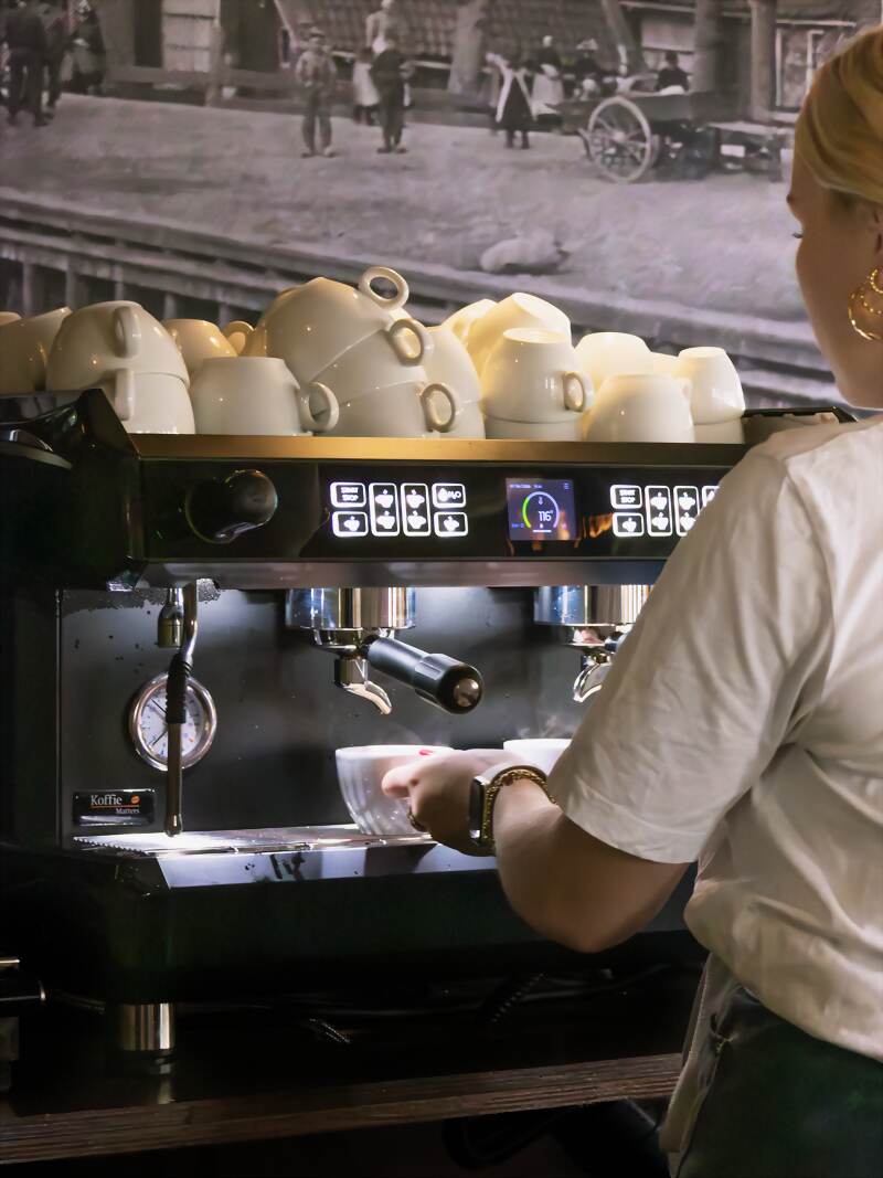 Verse koffie wordt gezet achter de espressomachine